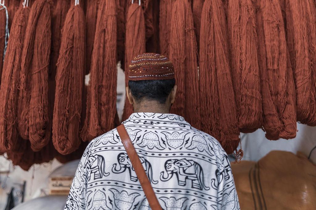 Traveler greeting local people in traditional attire